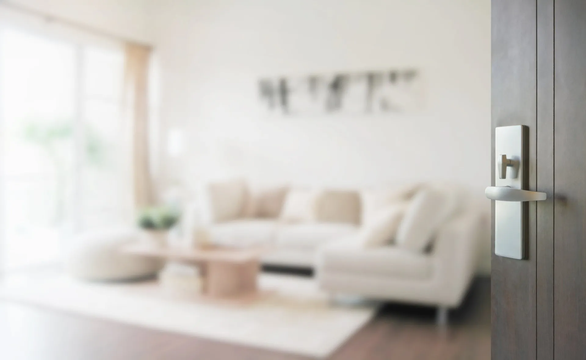 A blurry photo of a living room with white furniture.